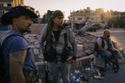 Drúzski ozbrojenci stoja 24. júla na centrálnom námestí v meste Sweida, zatiaľ čo sa v blízkosti zhromažďuje konvoj sunnitských moslimských obyvateľov, ktorí majú byť evakuovaní.