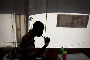 Pacient s cholerou si umýva zuby na cholerovej klinike v Port-au-Prince.