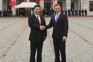 Čínsky prezident Si Ťin-pching (vľavo) si podáva ruku so svojím poľským partnerom Andrzejom Dudom.