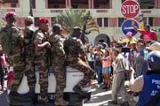 Vojaci sú vítaní ľuďmi zhromaždenými na slávnostnom obrade na pamiatku demonštrantov zabitých počas nedávnych protivládnych protestov v Antananarive na Madagaskare.
