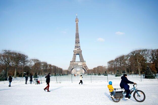 Ľudia pred Eiffelovou vežou v Paríži.