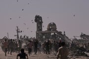 Palestínčania zbierajú letáky zhadzované izraelským dronom varujúce ľudí, aby sa nevzdiaľovali z tzv. žltej zóny v meste Chán Júnis, na juhu Pásma Gazy 20. októbra 2025.
