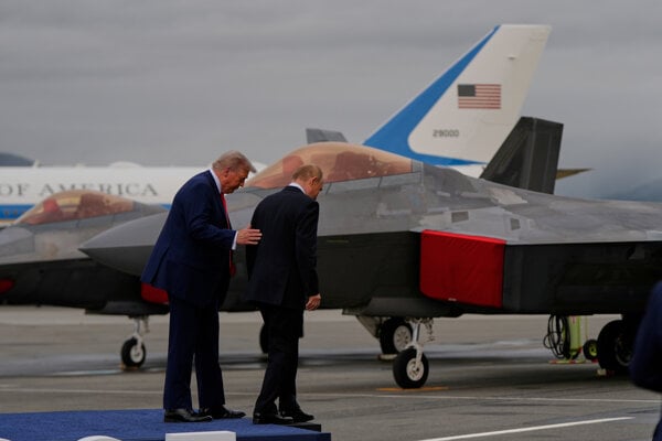 Trump a Putin na leteckej základni Elmendorf–Richardson. V pozadí stíhačka F-22. 