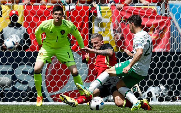Wes Hoolahan (v bielom) sa snaží dostať do zakončenia pred belgickým brankárom Thibautom Courtoisom. Bráni ho Toby Aldeweireld.