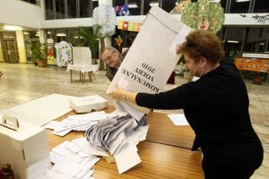 Election officials get ready to count the ballots on November 27.