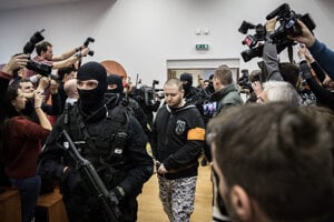 Miroslav Marček is escorted to the courtroom.