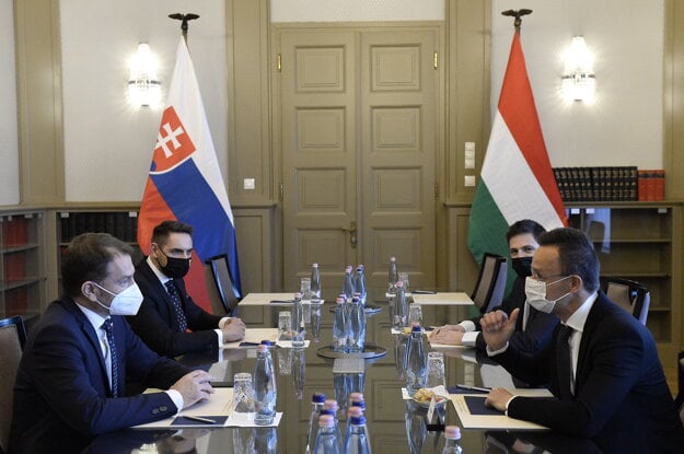 Hungarian Minister of Foreign Affairs and Trade Péter Szijjártó (r) and Slovak Finance Minister Igor Matovič (l) talk during their meeting at the Ministry of Foreign Affairs and Trade in Budapest, Hungary, Friday, April 9.