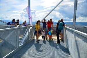 Visitors to the newly opened lookout tower outside Brezno enjoy the views of hills surrounding the town.