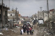 Iraqi civilians flee their homes during fighting between Iraqi security forces and Islamic State militants, on the western side of Mosul, Iraq, in March 2017.