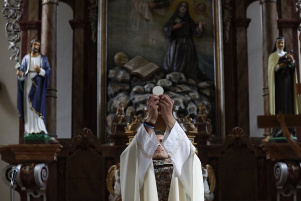 Michal Lajcha serves a mass in a church in Kľak.