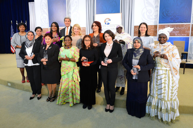 US Secretary of State John Kerry and US Ambassador-at-Large for Global Women's Issues Cathy Russell pose for a photo with the 2016 Secretary of State’s International Women of Courage Award winners at the U.S. Department of State in Washington, D.C., on March 29, 2016.