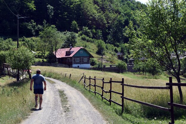 A man walks along a road in the Kýčera settlement in the Kysuce region.