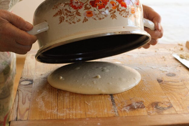 Warm a pot to keep the dough warm while it rests.