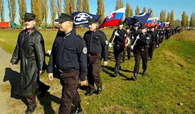 Kotleba (left) marching to the memorial in Šulekovo with Slovak Togetherness supporters in 2005.