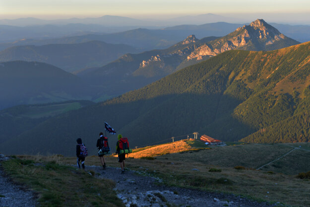 Tourists walk down from the Veľký Kriváň peak.