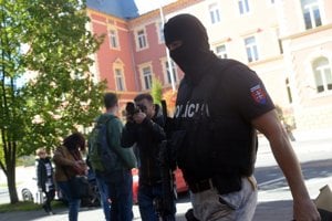 Member of soecial police unit (R) during the hearing of four defendants at the Specialised Criminal Court in Banská Bystrica. 