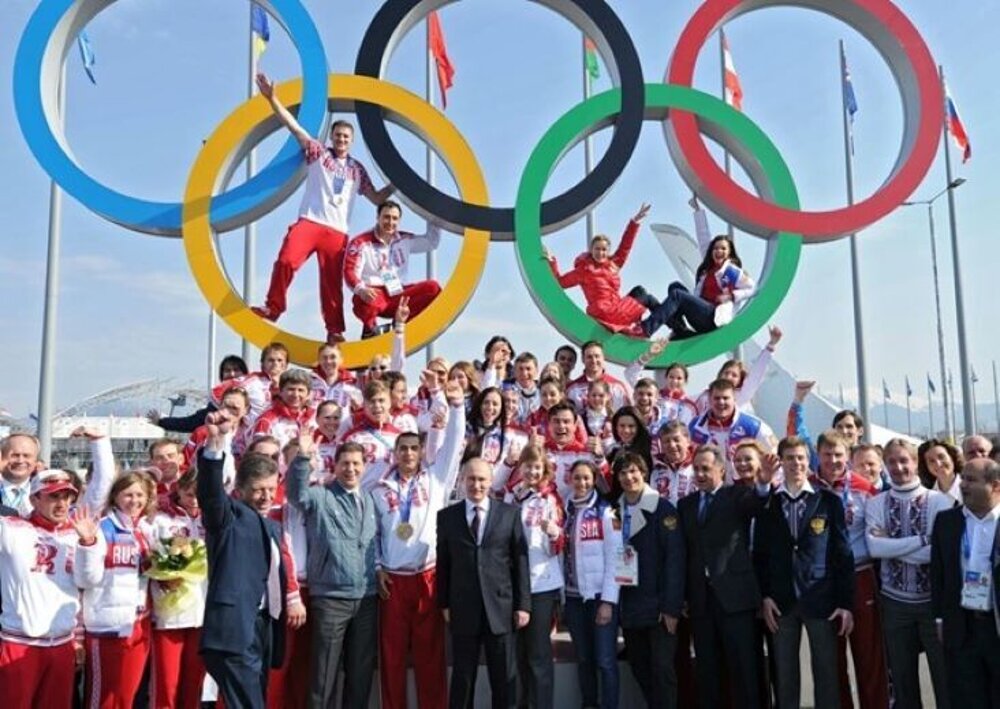 Russian President Vladimir Putin poses with all Russian medalists after the Sochi Games. Six of them have lost their medals to doping so far.