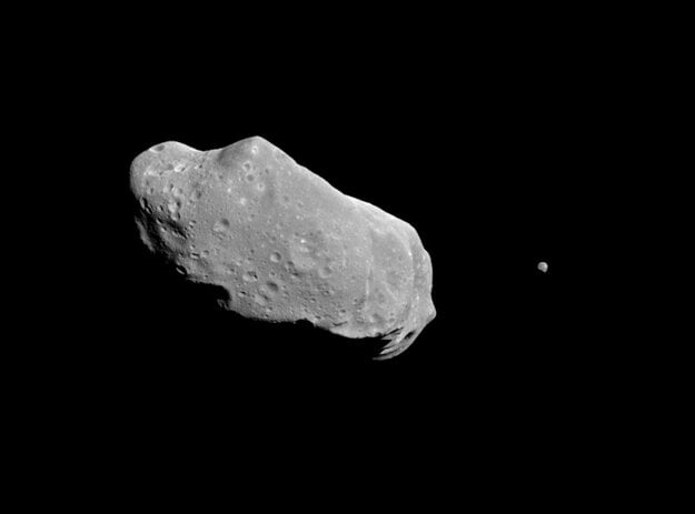 A picture showing both asteroid 243 Ida and its newly discovered moon. Ida, the large object, is about 56 kilometres long. Ida's natural satellite is the small object to the right.