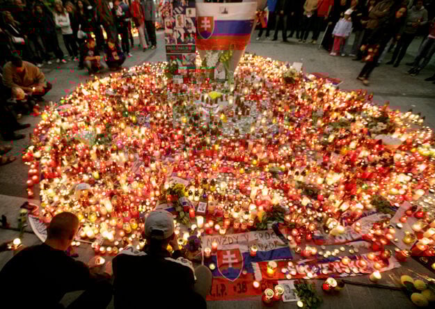 People lit candles in front of the Winter Stadium in Bratislava in honor of Pavol Demitra on September 9, 2011.