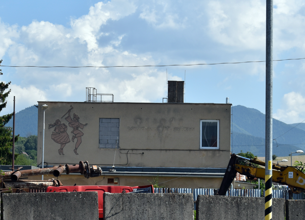 A dancing couple wearing folk costumes is portrayed on the wall of a building in the Rajec town, Žilina Region.