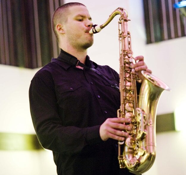 Playing on saxophone, illustrative stock photo.