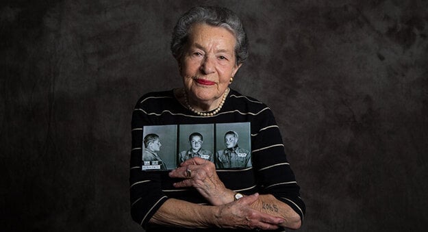 Lotte Weiss holds her concentration camp mugshot, taken in Auschwitz, June 20, 1942.