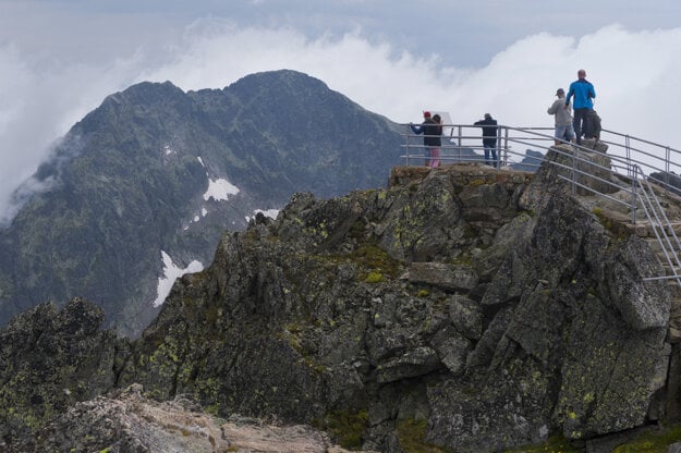 Tourists enjoy the view from Lomnický Štít in the High Tatras.