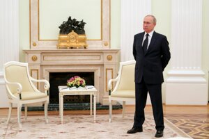 Russian President Vladimir Putin stands while waiting for Belarusian President Alexander Lukashenko prior to their talks in Moscow, on March 11, 2022.