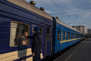 A man bids farewell to his nine year old daughter as the train with his family leaves for Poland, at the train station in Odesa, on Monday, April 4, 2022.