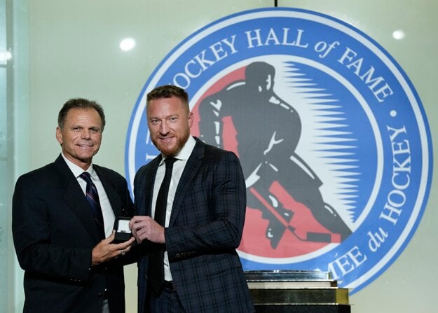 Mike Gartner, left, presents a ring to Hockey Hall of Fame inductee Marian Hossa in Toronto, Friday, November 12, 2021. 